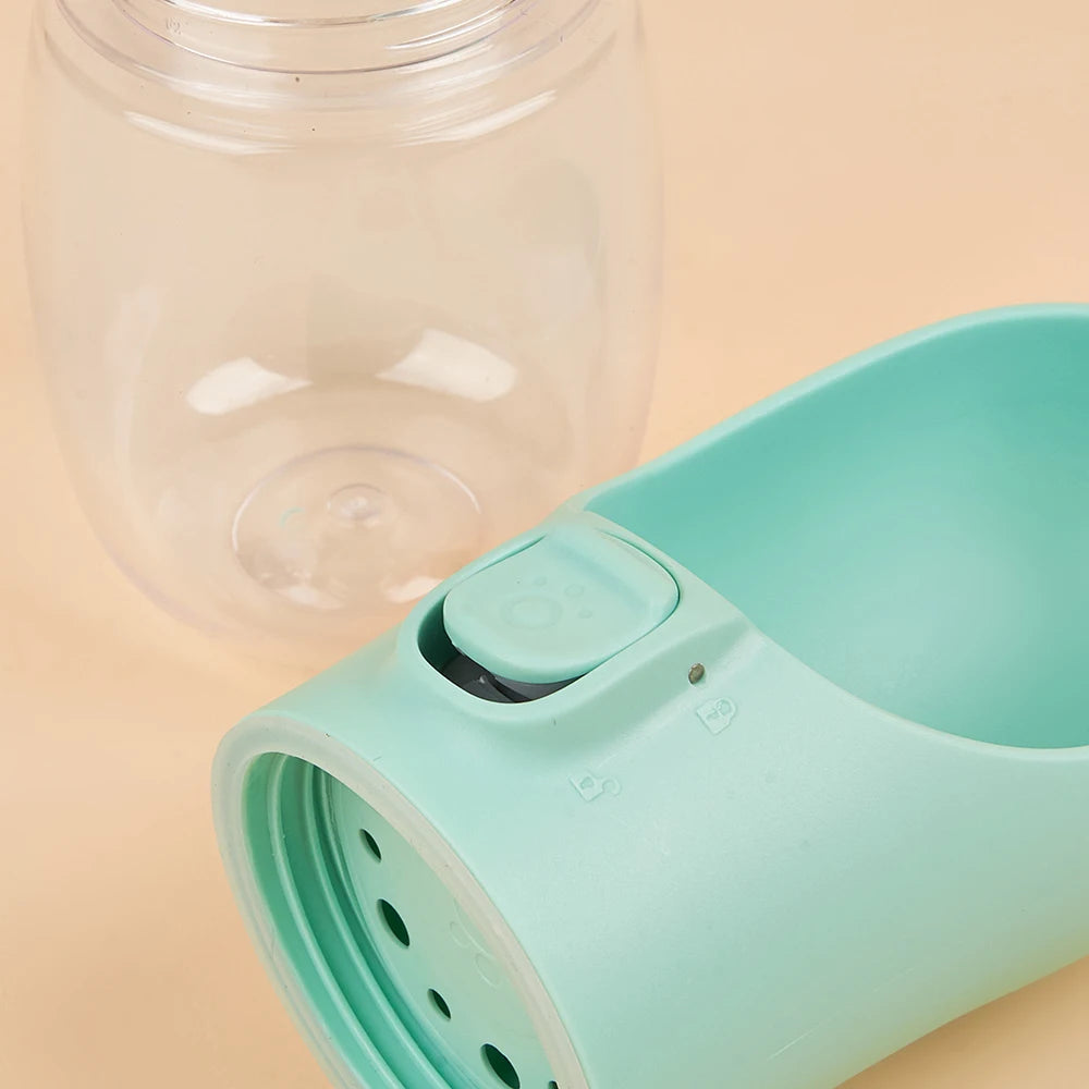 Dog drinking water from flip-out bowl on portable travel water bottle